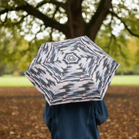 Totes ECO Tiny X-tra Strong Folding Umbrella - Mini Striped Clouds - lifestyle view - Umbrella World